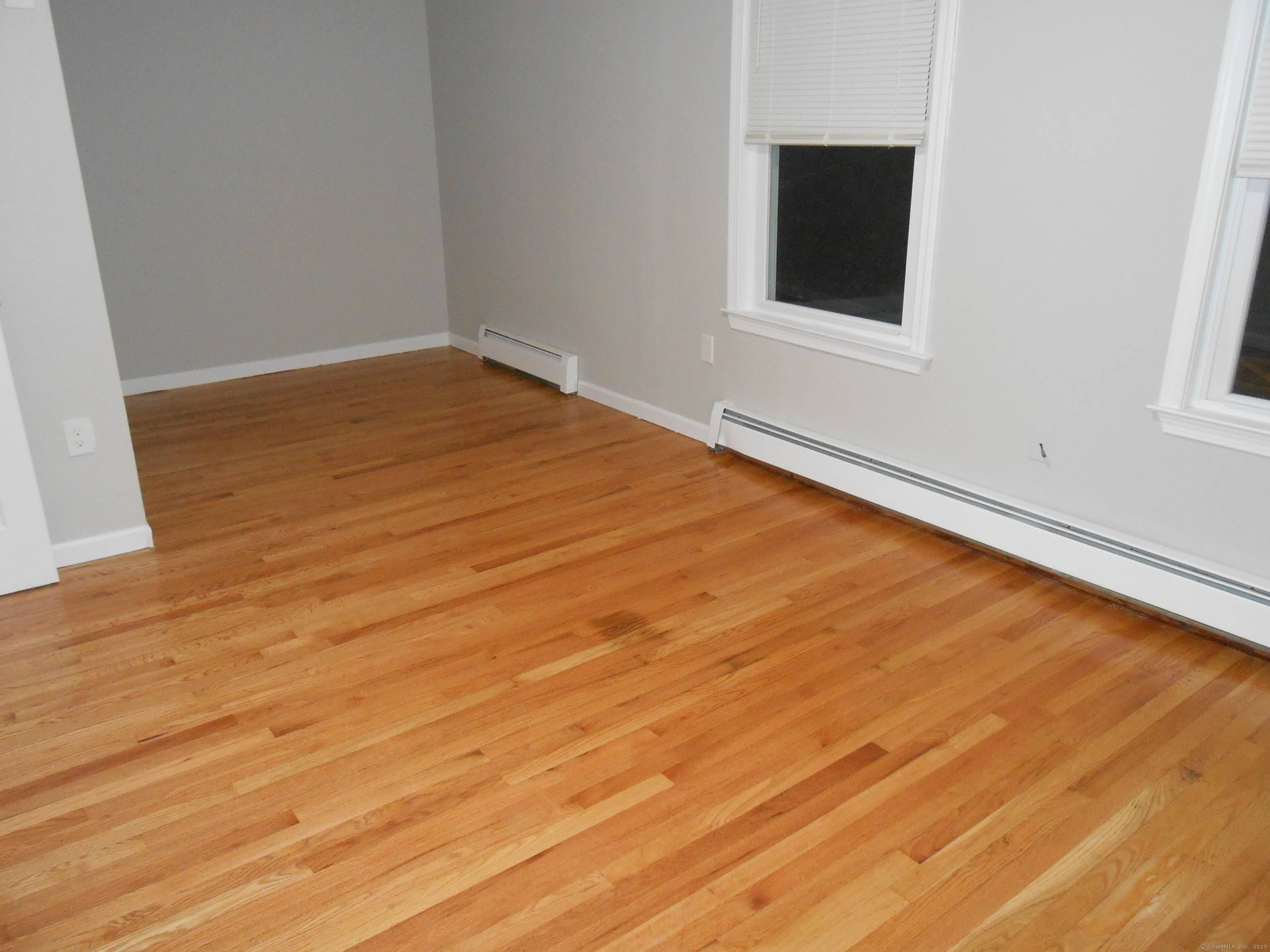 631 Whalley Avenue New Haven, CT 06511 - Photo 2 of 28 a view of an empty room with wooden floor and a window