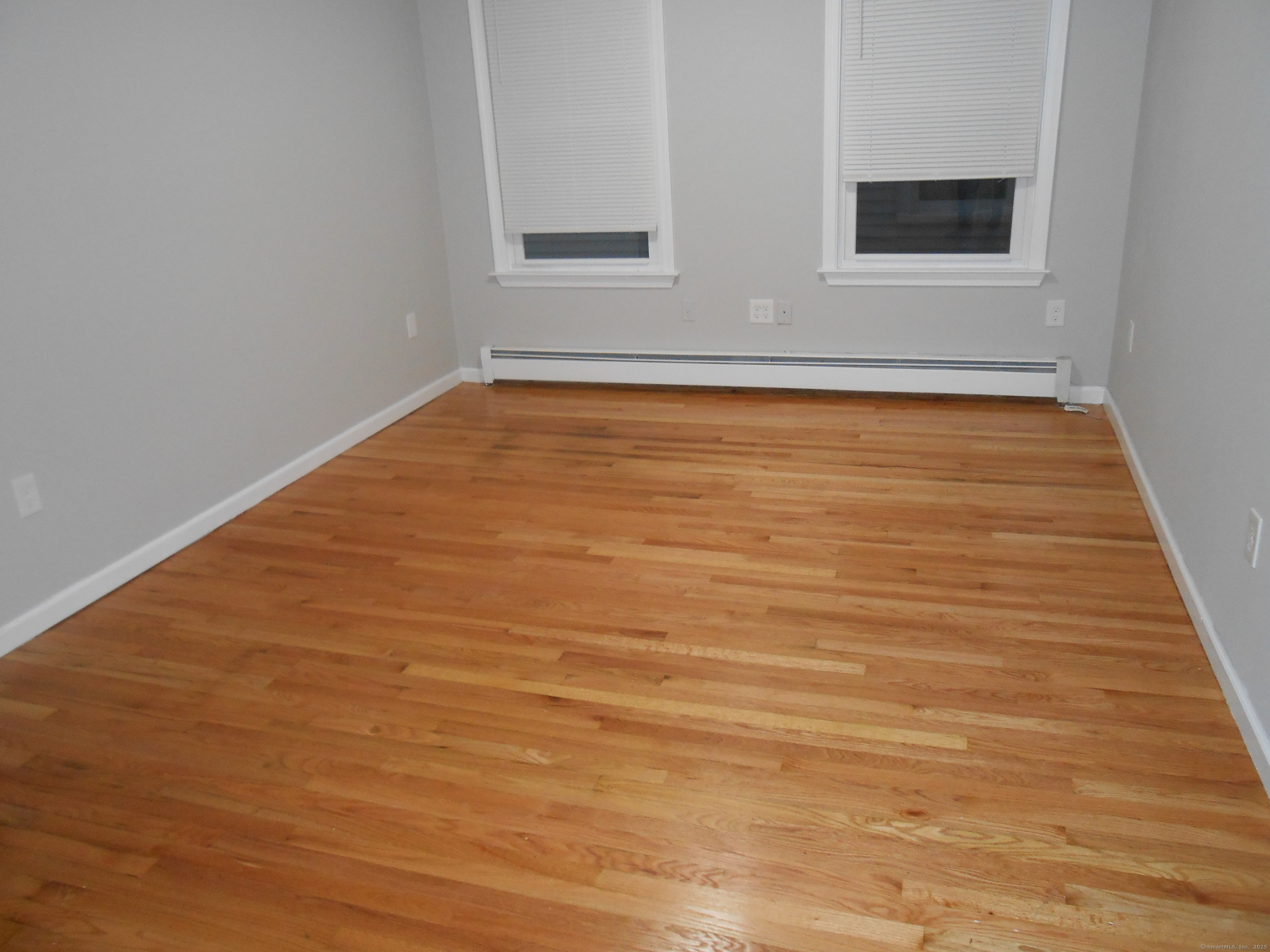 631 Whalley Avenue New Haven, CT 06511 - Photo 27 of 28 a view of an empty room with wooden floor and a window