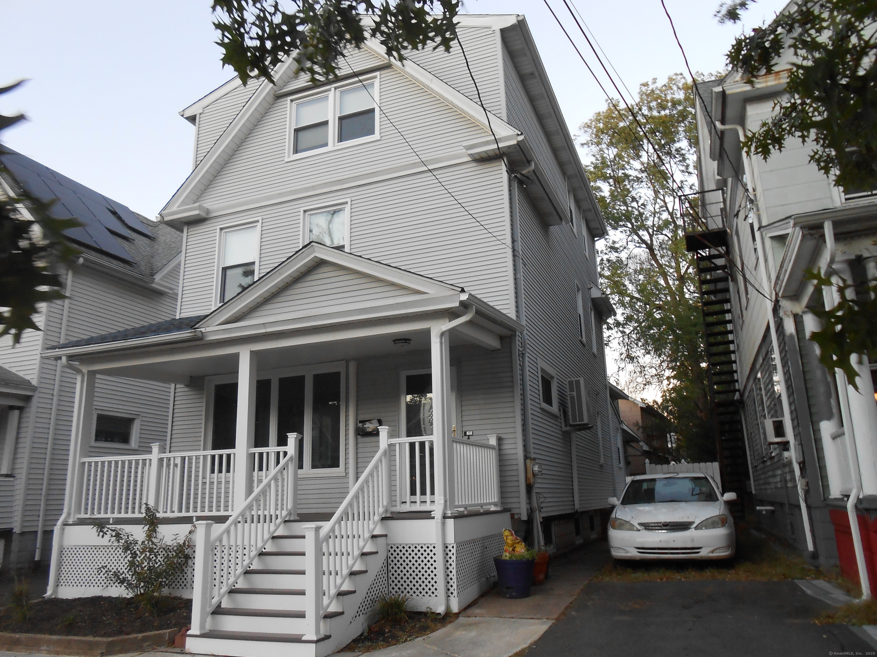 631 Whalley Avenue New Haven, CT 06511 - Photo 4 of 28 a view of a white house with a small yard and furniture