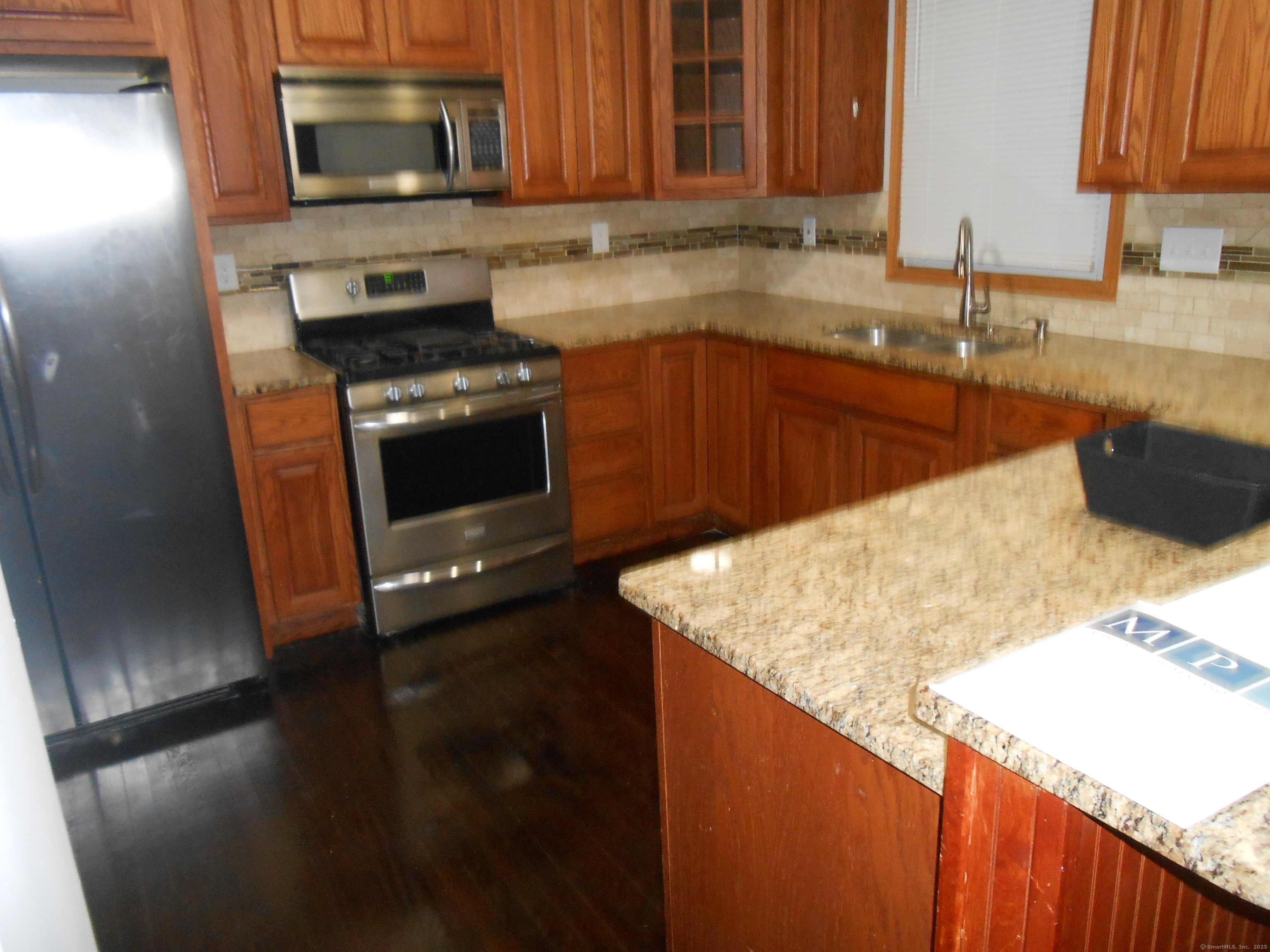 631 Whalley Avenue New Haven, CT 06511 - Photo 10 of 28 a kitchen with a sink stove and microwave