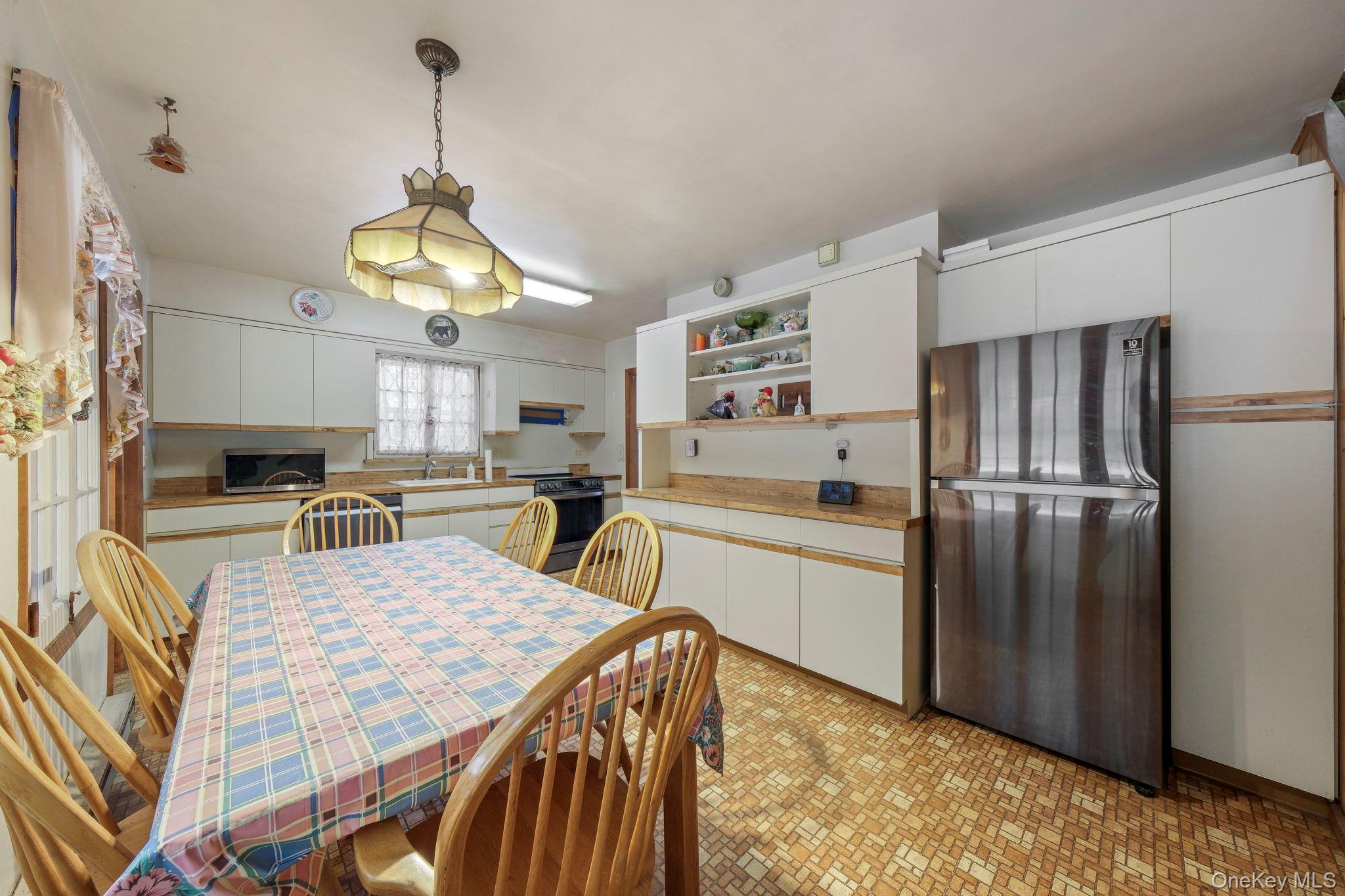 194 Canal Road Wurtsboro, NY 12790 - Photo 13 of 43 a kitchen with stainless steel appliances granite countertop a sink dishwasher a refrigerator a kitchen island a stove and a refrigerator with wooden floor
