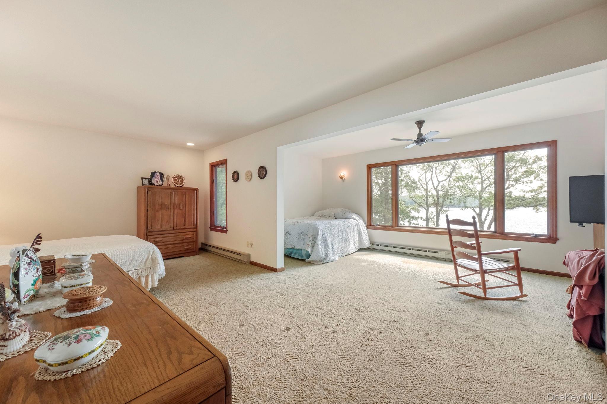 194 Canal Road Wurtsboro, NY 12790 - Photo 25 of 43 a spacious bedroom with a bed and large windows