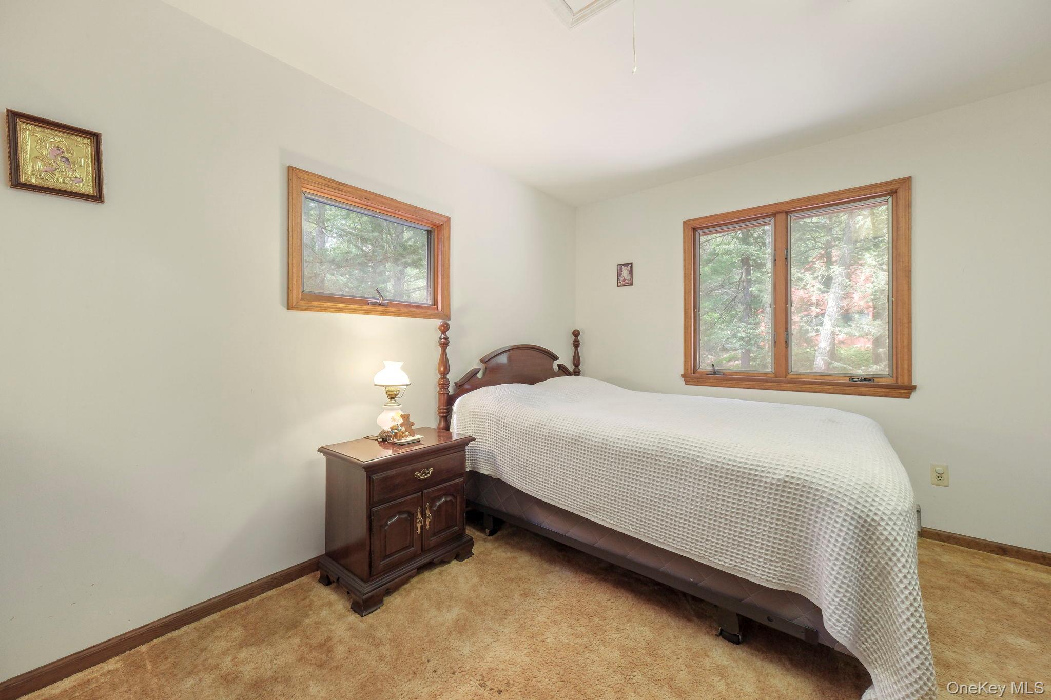 194 Canal Road Wurtsboro, NY 12790 - Photo 32 of 43 a bedroom with a bed and a window