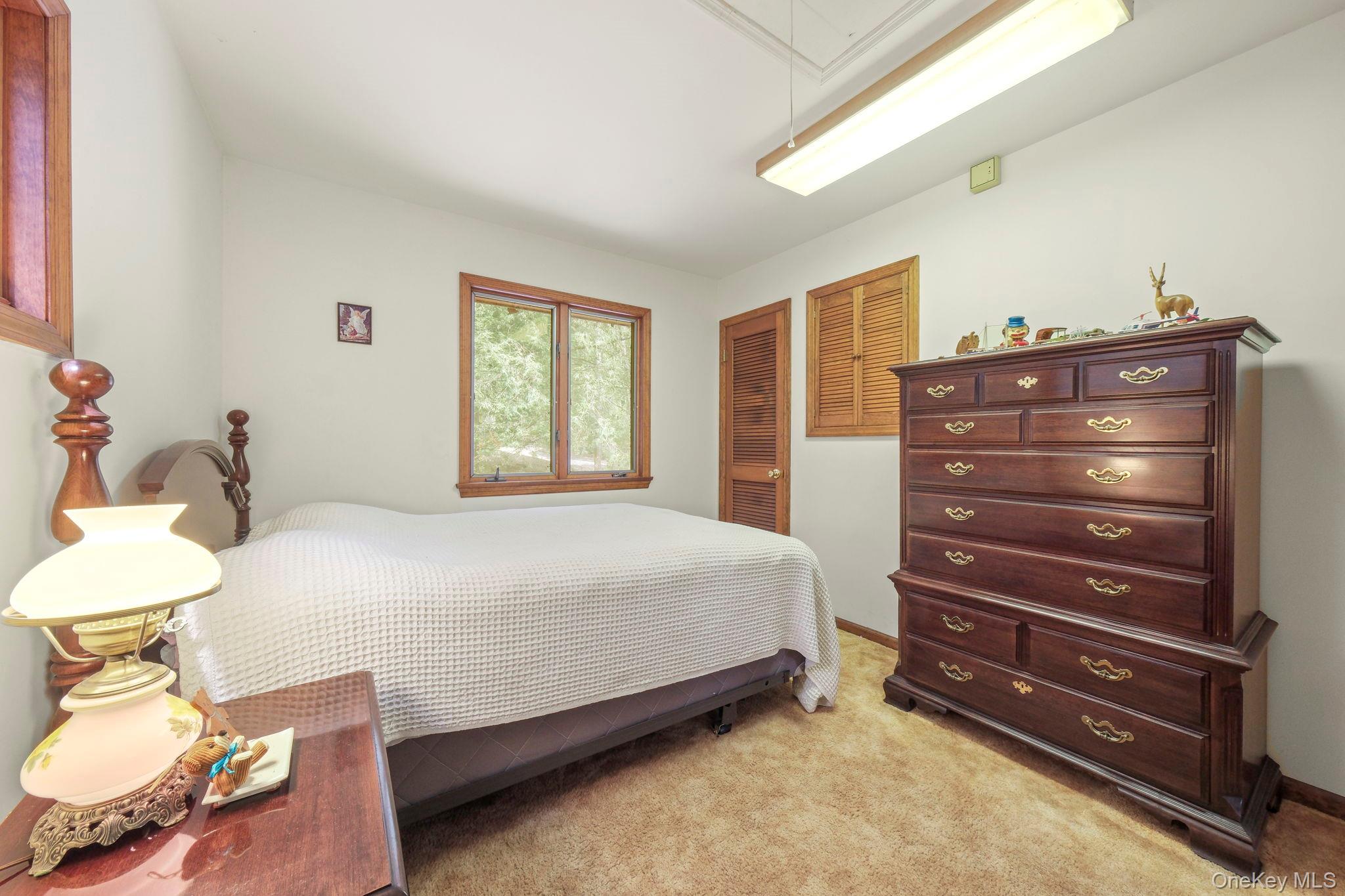 194 Canal Road Wurtsboro, NY 12790 - Photo 33 of 43 a bedroom with a bed and a dresser