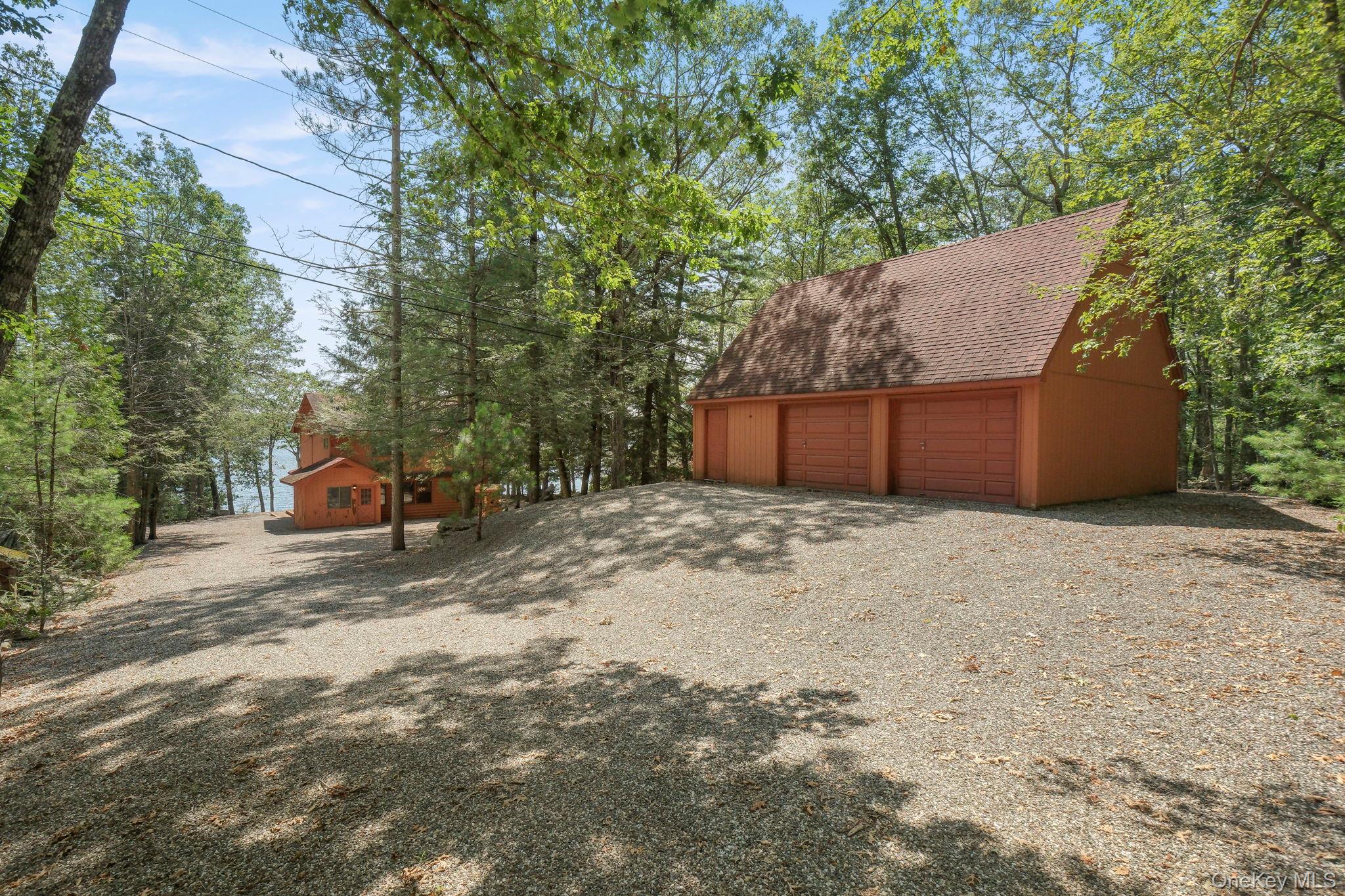 194 Canal Road Wurtsboro, NY 12790 - Photo 36 of 43 a backyard of a house with wooden fence and large trees