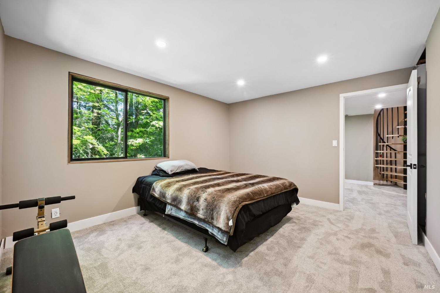 21713 Starrett Hill Drive Monte Rio, CA 95462 - Photo 35 of 50 a bedroom with a bed and a window