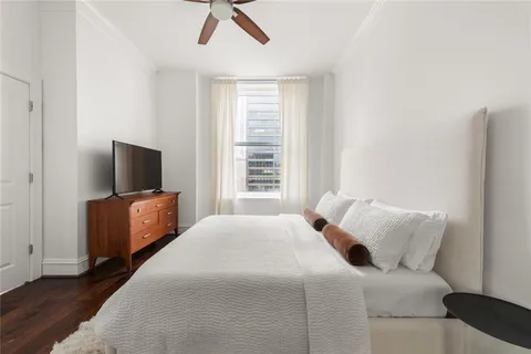 a bedroom with a bed and a television