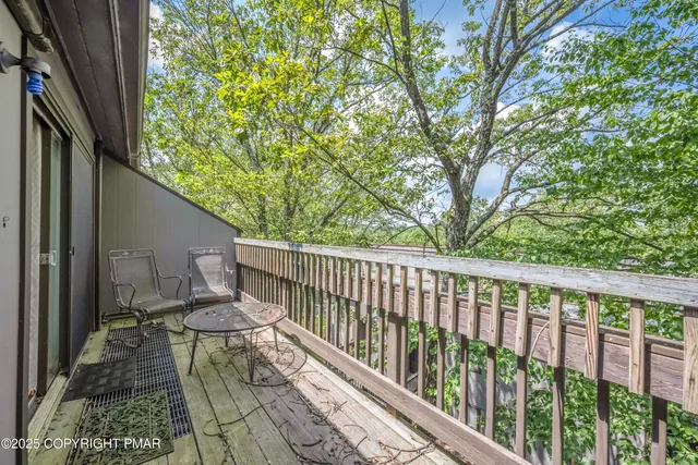 a view of balcony with wooden floor and fence