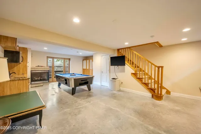 a kitchen with stainless steel appliances a stove a sink cabinets and wooden floor