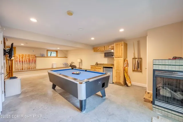 a room with wooden floor a table and chairs