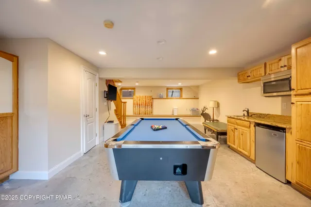 a living room with furniture and a kitchen area