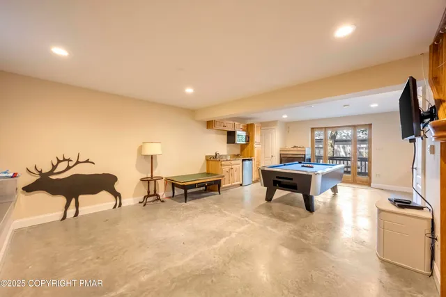 a spacious bedroom with a bed and glass windows