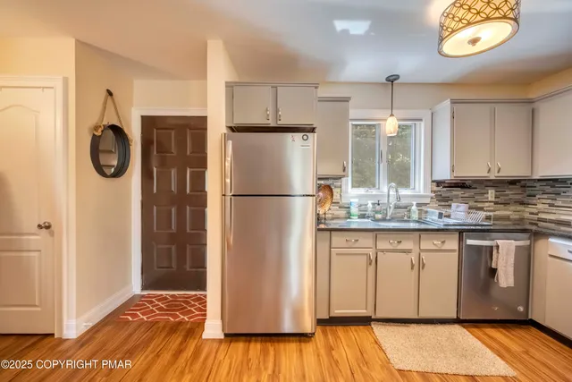 a kitchen with a refrigerator and a sink