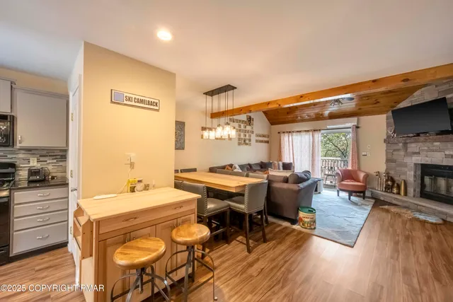 a living room with fireplace furniture and a wooden floor