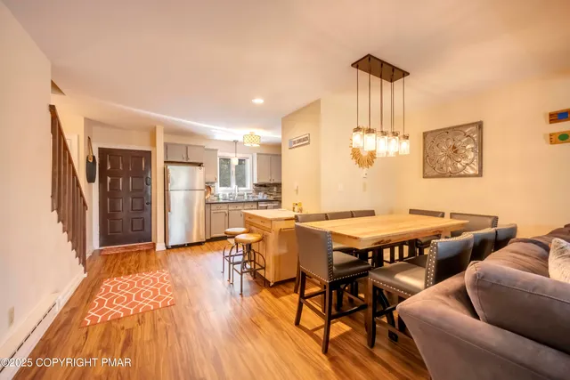 a dining room with furniture and wooden floor