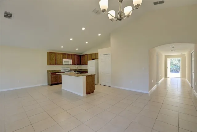 a kitchen with stainless steel appliances granite countertop a sink and a refrigerator