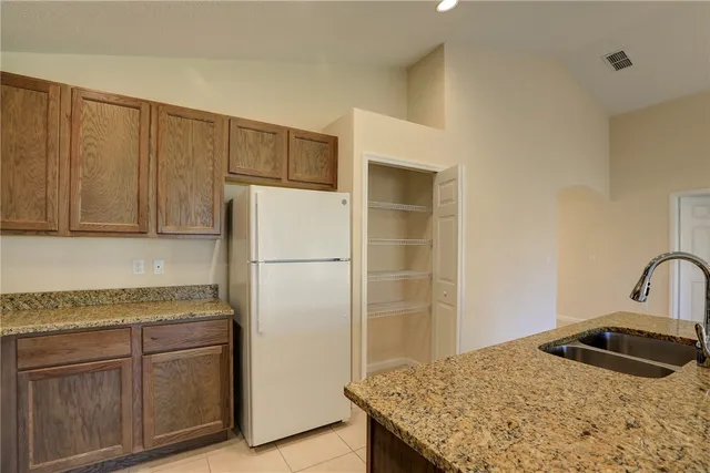 a kitchen with a sink cabinets and appliances