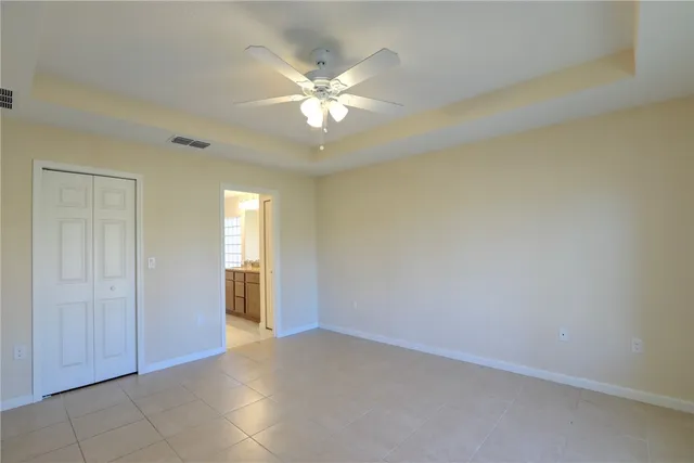 a bathroom with a granite countertop sink a mirror and a bathtub