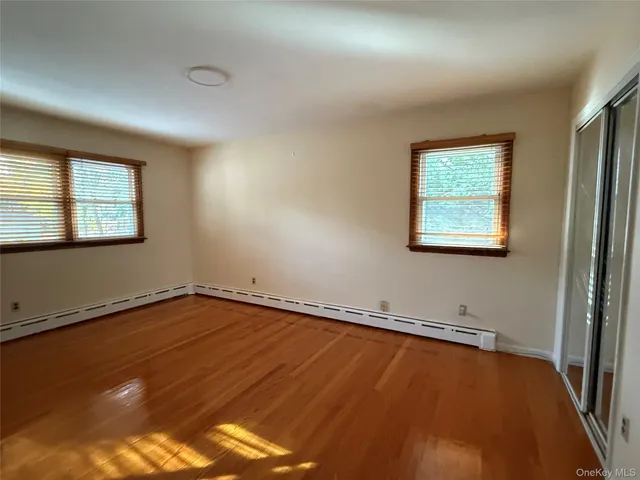 a view of a room with wooden floor and window