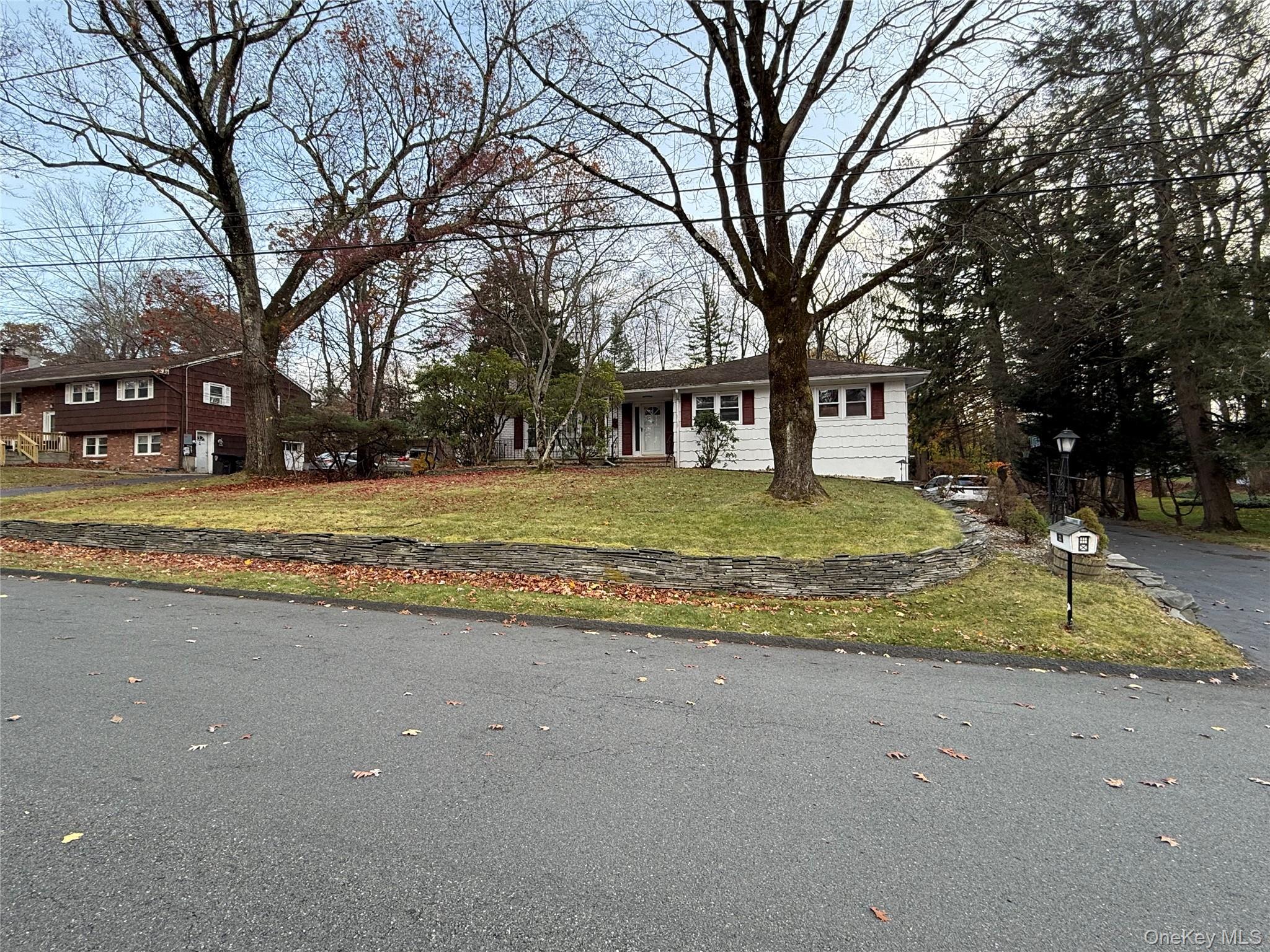 10 Glenbrook Road Monsey, NY 10952 - Photo 15 of 16 a view of a house with trees in the background