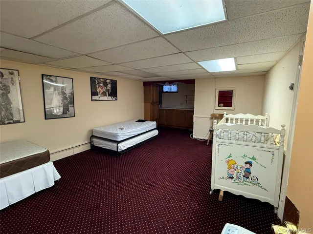 a living room with furniture and a baby crib