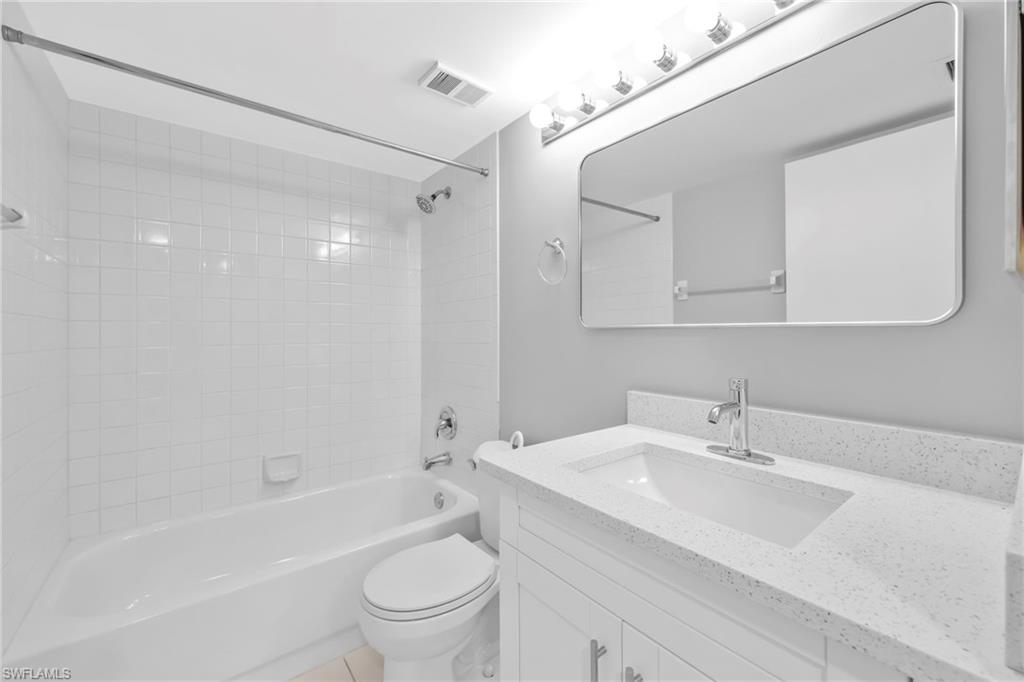 7791 Esmeralda Way, Unit L103 Naples, FL 34109 - Photo 11 of 22 a bathroom with a sink a toilet and a bathtub