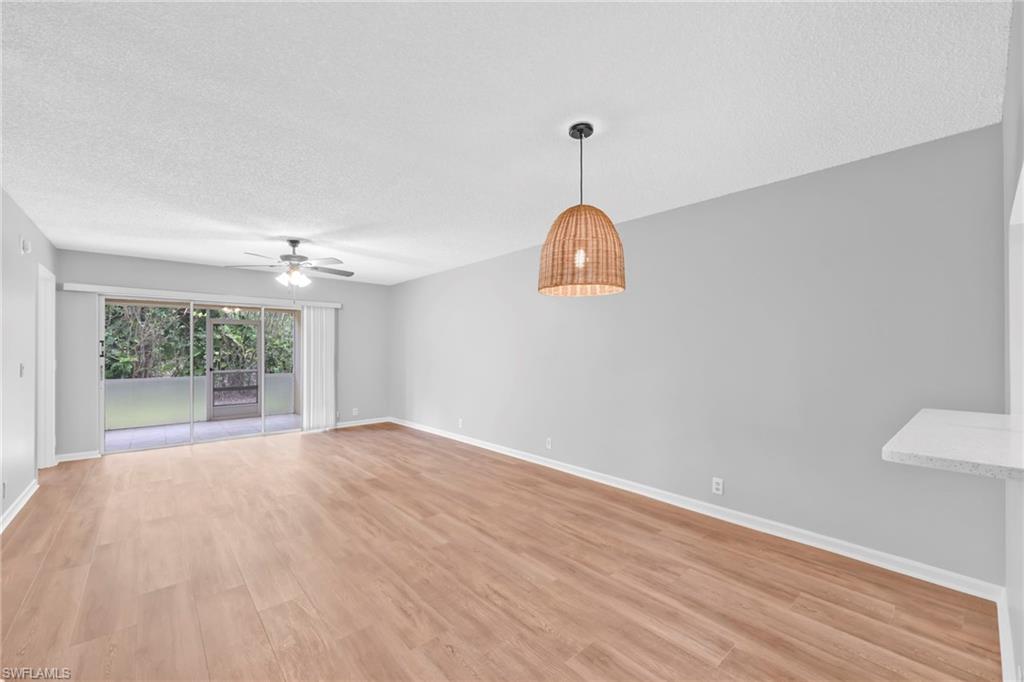 7791 Esmeralda Way, Unit L103 Naples, FL 34109 - Photo 12 of 22 a view of a room with a window and wooden floor