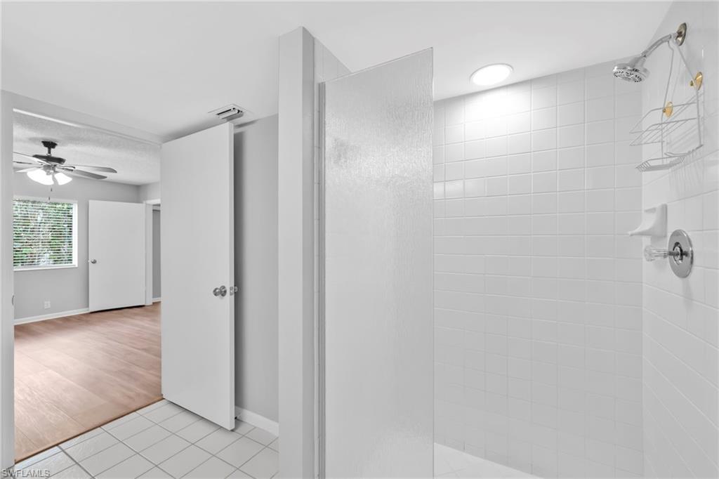 7791 Esmeralda Way, Unit L103 Naples, FL 34109 - Photo 21 of 22 a bathroom with a shower and a glass door