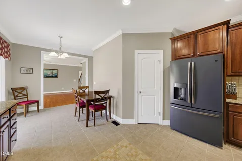 a kitchen with granite countertop wooden cabinets a sink and a window