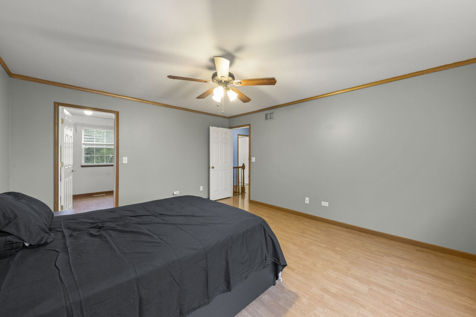 16727 South Sunset Ridge Court Lockport, IL 60441 - Photo 14 of 30 a bedroom with a bed and a chandelier