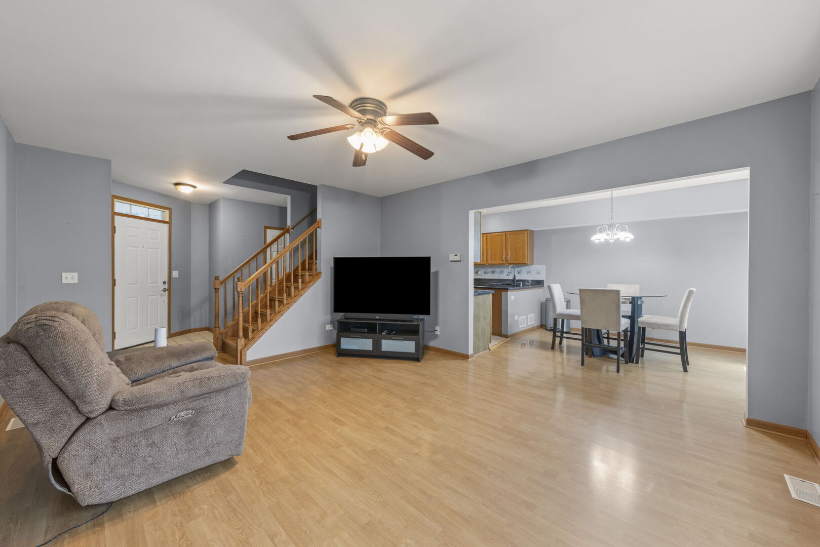 16727 South Sunset Ridge Court Lockport, IL 60441 - Photo 6 of 30 a living room with furniture and a flat screen tv with kitchen view
