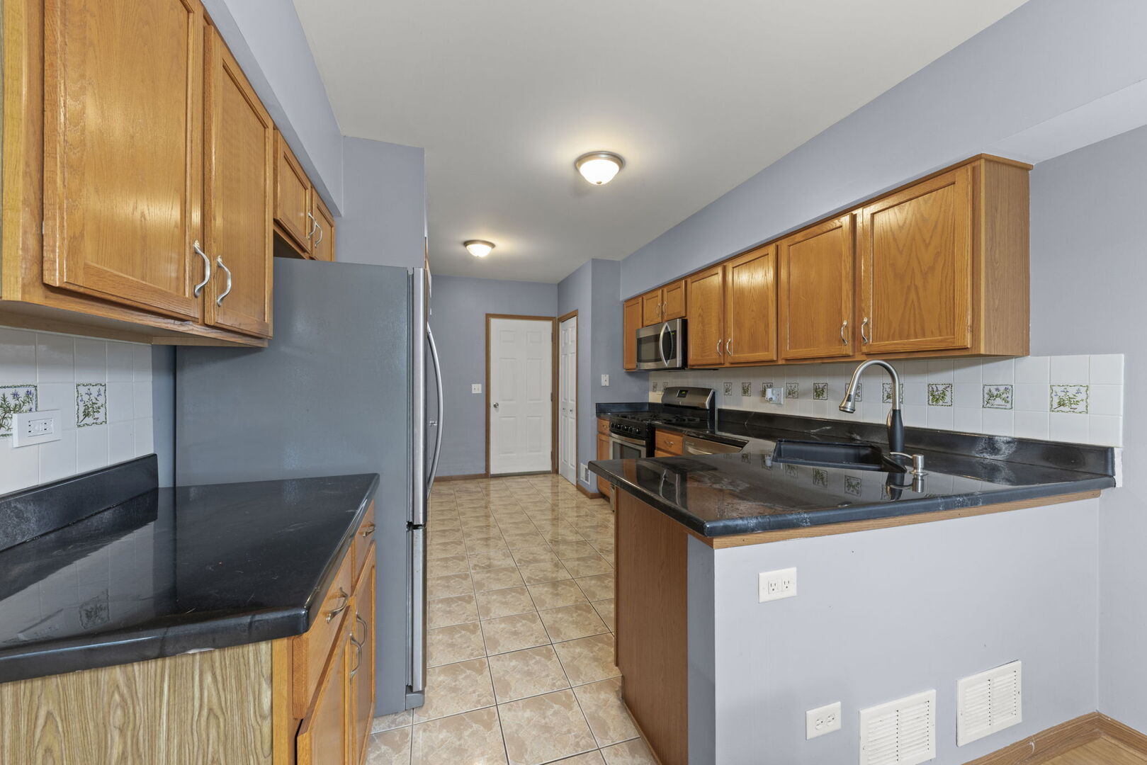 16727 South Sunset Ridge Court Lockport, IL 60441 - Photo 9 of 30 a kitchen with granite countertop a sink and a stove