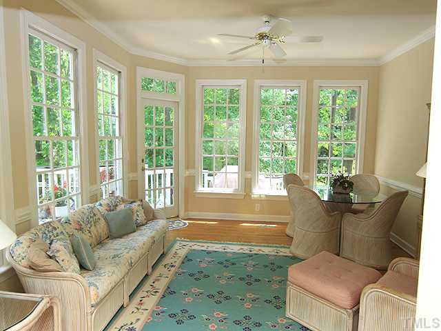 113 Raphael Drive Cary, NC 27511 - Photo 11 of 16 The sunroom is the perfect place for morning coffee while enjoying the private backyard. The room also has access to one of the many porches in the home. The gleaming hardwoods and window are indicative of the custom features throughout this home. Sun Room