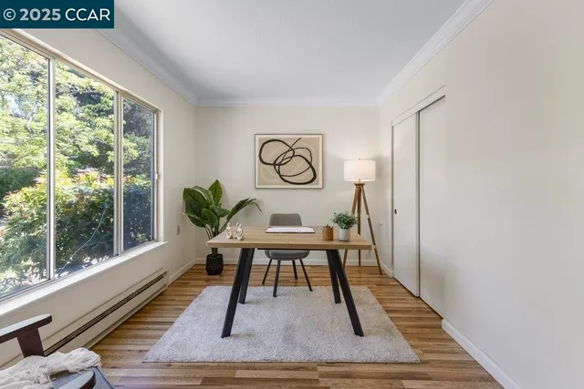 a view of a room with furniture and wooden floor