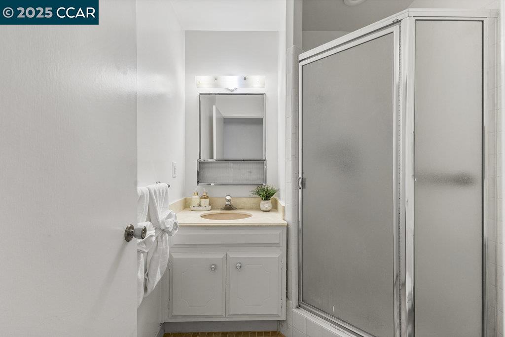 1833 Skycrest Drive, Unit 2 Walnut Creek, CA 94595 - Photo 19 of 28 a bathroom with a sink toilet and shower