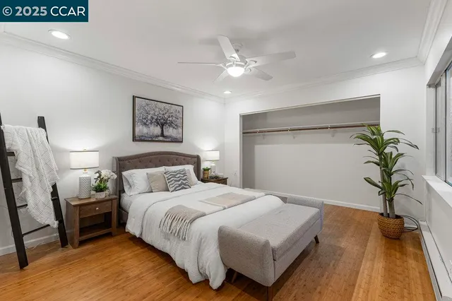 a bedroom with a large bed and a chandelier