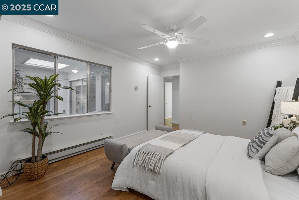 1833 Skycrest Drive, Unit 2 Walnut Creek, CA 94595 - Photo 23 of 28 a bedroom with a large bed and a chandelier