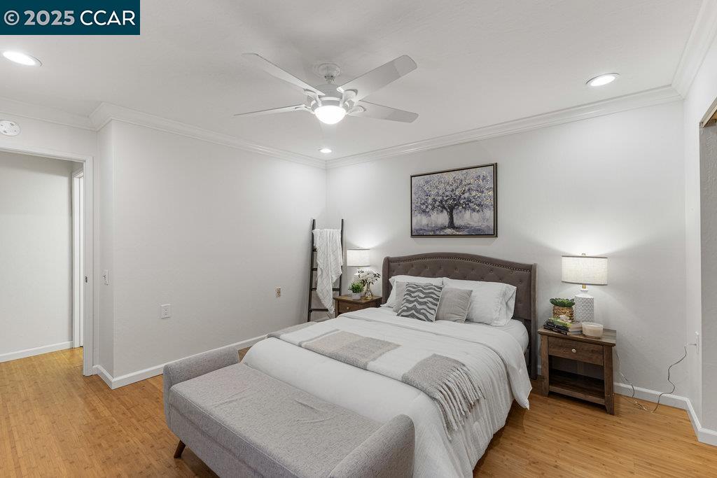 1833 Skycrest Drive, Unit 2 Walnut Creek, CA 94595 - Photo 24 of 28 a bedroom with a large bed and a chandelier