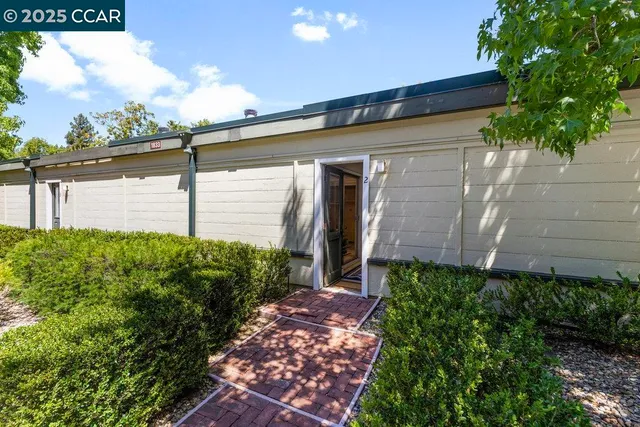 a view of a back yard of the house and front view of a house