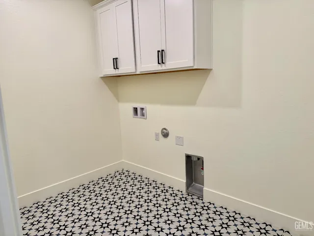 a view of a room with wooden floor chandeliers and kitchen view