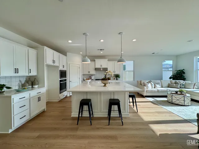 a large kitchen with a table and chairs