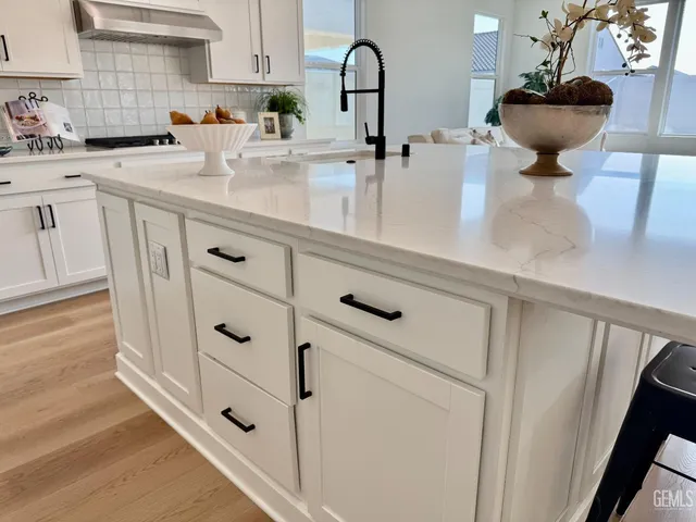 a kitchen with cabinets and window