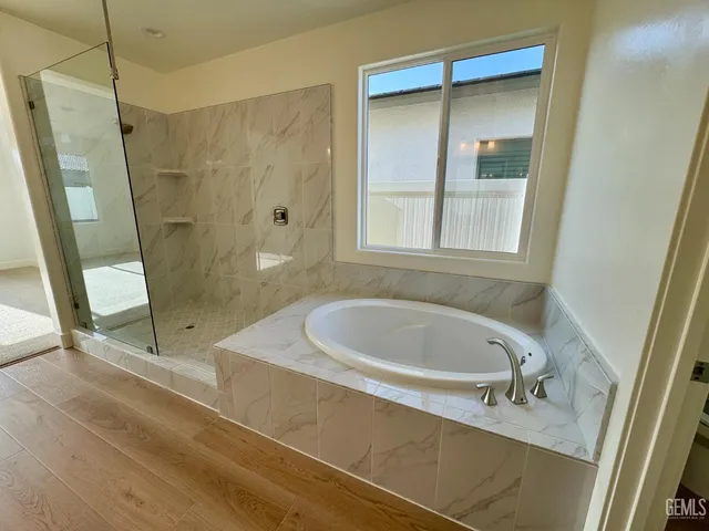 a bath tub sitting next to a shower