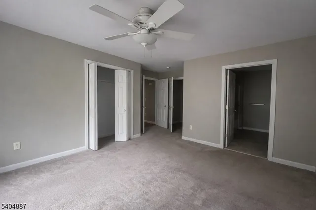 an empty room with a ceiling fan and a ceiling fan