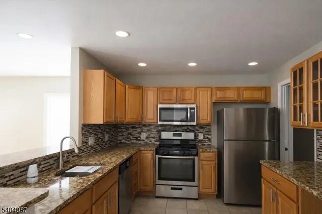 a kitchen with a refrigerator sink and microwave