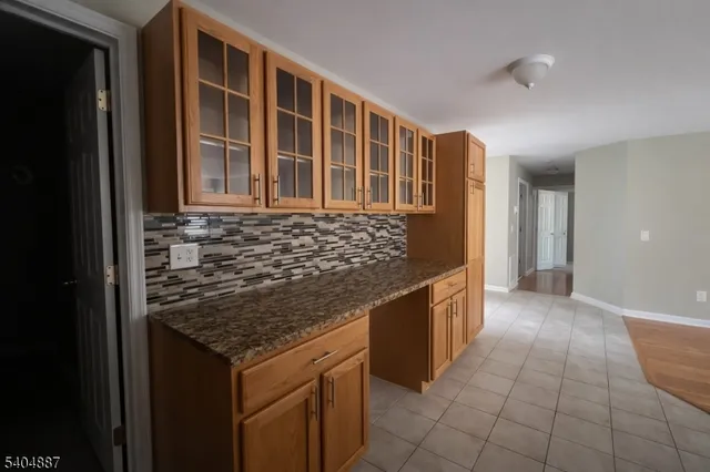 a kitchen with granite countertop a sink and a stove