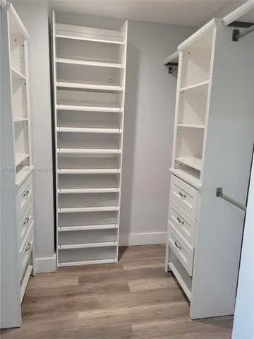 a view of walk in closet with empty racks