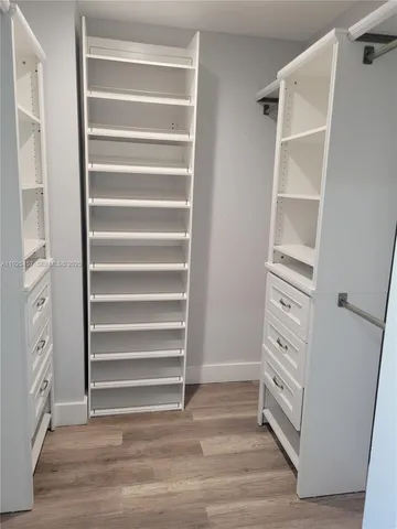 a view of walk in closet with empty racks