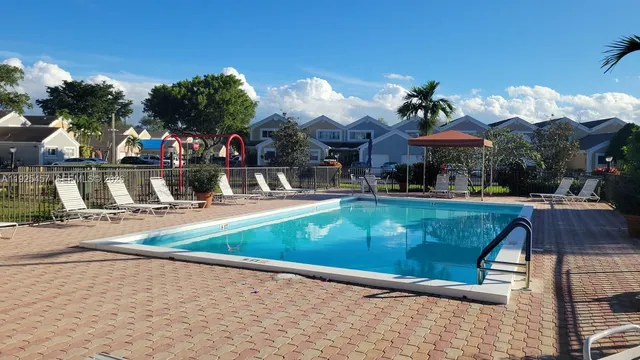 a view of a backyard with swimming pool
