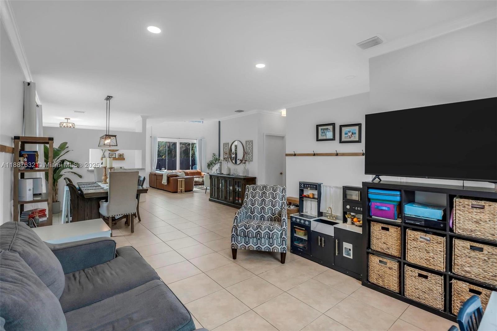 14836 Southwest 51st Street Davie, FL 33331 - Photo 12 of 34 a living room with furniture and a flat screen tv